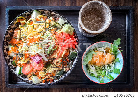 Delectable Chirashi bowl with fresh salmon, roe, and a side salad Delectable Chirashi bowl with fresh salmon, roe, and a side salad 140586705