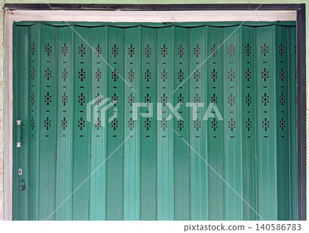 Vibrant vintage Hong Kong traditional green metal door with intricate design patterns and texture Vibrant vintage Hong Kong traditional green metal door with intricate design patterns and texture 140586783