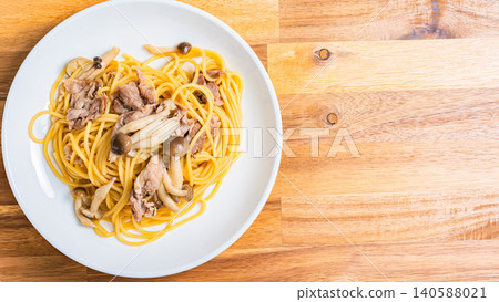 Japanese-style pasta with pork slices and mushrooms Japanese-style pasta with pork slices and mushrooms 140588021