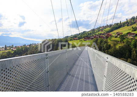 Suspension pedestrian panorama bridge over the Gummi gorge in Sigriswil, Switzerland Suspension pedestrian panorama bridge over the Gummi gorge in Sigriswil, Switzerland 140588283