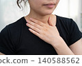 Asian woman touching her neck and throat for thyroid gland problem. 140588562