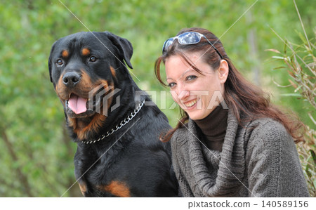woman and rottweiler in nature woman and rottweiler in nature 140589156