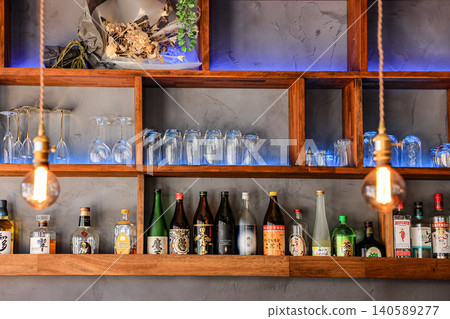 A shelf for storing liquor in a small suburban restaurant. A shelf for storing liquor in a small suburban restaurant. 140589277