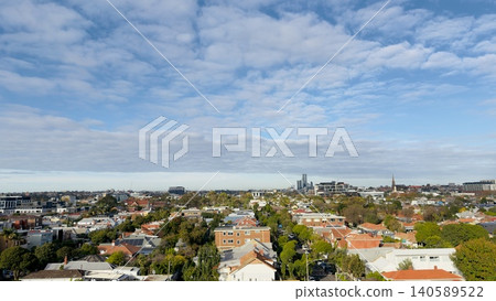 An elevated wide panoramic view of a suburban residential neighborhood with orange and red brick rooftops. An elevated wide panoramic view of a suburban residential neighborhood with orange and red brick rooftops. 140589522