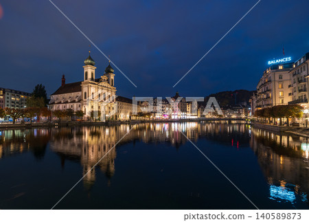 A night view of the old town along the Reuss River, with its illuminated historical buildings. Lucerne, Canton of Lucerne, Switzerland. A night view of the old town along the Reuss River, with its illuminated historical buildings. Lucerne, Canton of Lucerne, Switzerland. 140589873