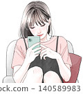 A woman sitting in a chair and using her smartphone. 140589983
