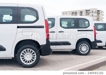 White delivery vans are parked in rows. Commercial fleet of vehicles. White delivery vans are parked in rows. Commercial fleet of vehicles. 140591182
