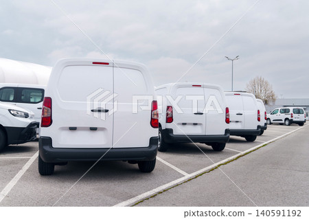 White delivery vans are parked in rows. Commercial fleet of vehicles White delivery vans are parked in rows. Commercial fleet of vehicles 140591192