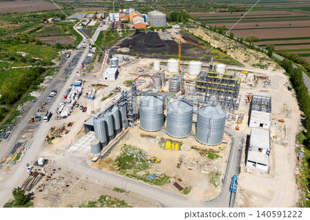 Construction site of a modern agricultural complex with silos, grain elevator and storage terminal. Aerial view Construction site of a modern agricultural complex with silos, grain elevator and storage terminal. Aerial view 140591222