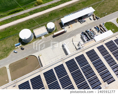 Aerial view of a modern logistics center with solar panels on the roof Aerial view of a modern logistics center with solar panels on the roof 140591277