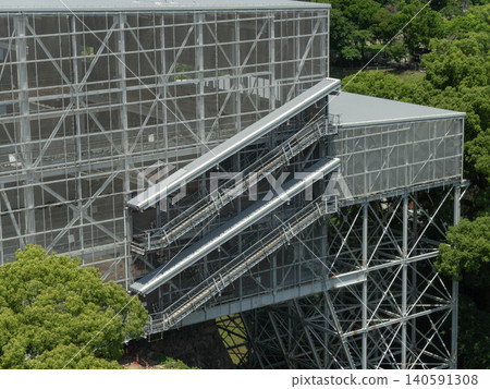 Large metal frame architectural construction with stairs and platforms outdoor in a park. Large metal frame architectural construction with stairs and platforms outdoor in a park. 140591308