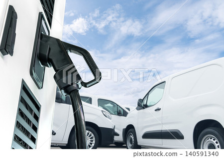 Electric vehicles charging station on a background of a row of vans. Green transportation concept. 140591340