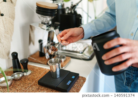 Man brewing espresso at home using a manual lever coffee machine. Man brewing espresso at home using a manual lever coffee machine. 140591374