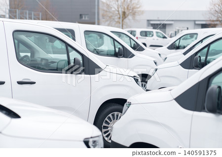 White delivery vans are parked in rows. Commercial fleet of vehicles. White delivery vans are parked in rows. Commercial fleet of vehicles. 140591375