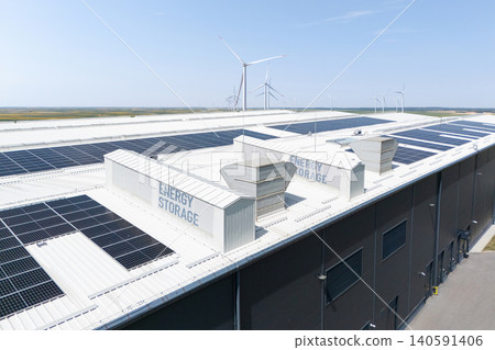 Aerial view of a modern logistics center with solar panels and energy storages on the roof 140591406