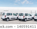 White delivery vans are parked in rows. Commercial fleet of vehicles 140591411