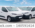 White delivery vans are parked in rows. Commercial fleet of vehicles 140591414