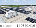 Aerial view of a modern logistics center with solar panels and energy storages on the roof 140591416