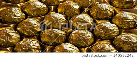 Golden candies in a big box Golden candies in a big box 140592242
