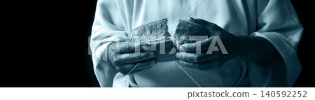 Man's hans holding fresh bread Man's hans holding fresh bread 140592252