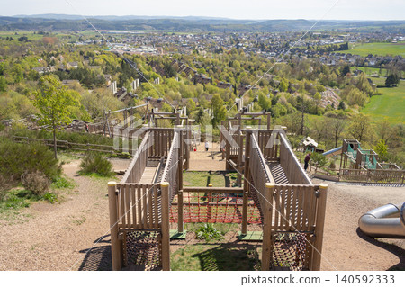 High angle panoramic view from a wooden observation deck overlooking a beautiful green valley and small town. Scenic landscape photography capturing European countryside and nature park. Elevated view High angle panoramic view from a wooden observation deck overlooking a beautiful green valley and small town. Scenic landscape photography capturing European countryside and nature park. Elevated view 140592333