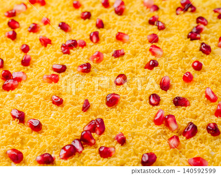 Grated egg yolk with vibrant pomegranate seeds topping Grated egg yolk with vibrant pomegranate seeds topping 140592599