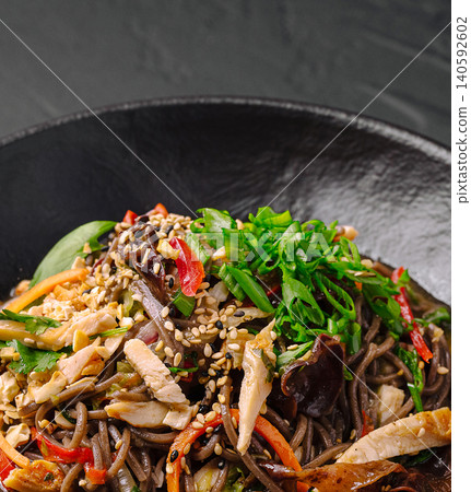 Soba noodles with chicken, vegetables, and sesame seeds Soba noodles with chicken, vegetables, and sesame seeds 140592602