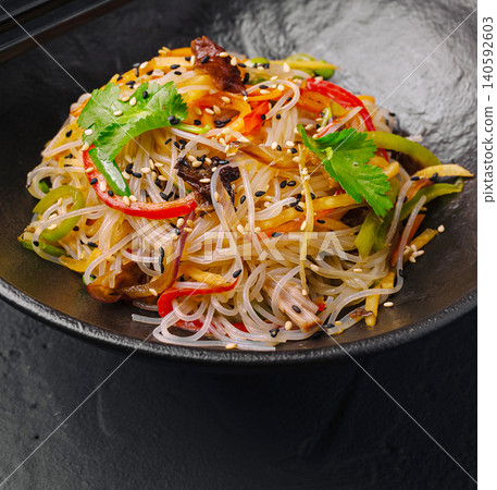 Glass noodles stir fry with vegetables and sesame seeds Glass noodles stir fry with vegetables and sesame seeds 140592603