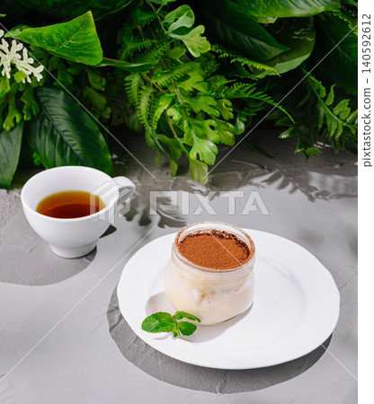 Tiramisu dessert in glass jar with tea cup 140592612