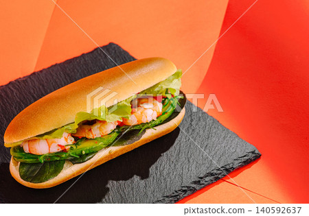 Shrimp sandwich with avocado and lettuce on slate Shrimp sandwich with avocado and lettuce on slate 140592637