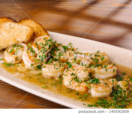 Garlic shrimp scampi with fresh parsley and toasted bread Garlic shrimp scampi with fresh parsley and toasted bread 140592809