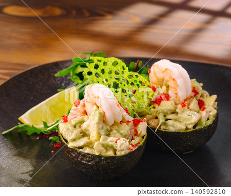 Shrimp and avocado salad served in halves Shrimp and avocado salad served in halves 140592810