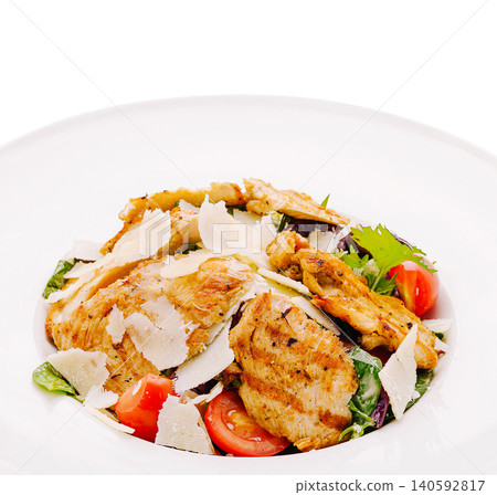 Grilled chicken caesar salad with parmesan and tomatoes 140592817