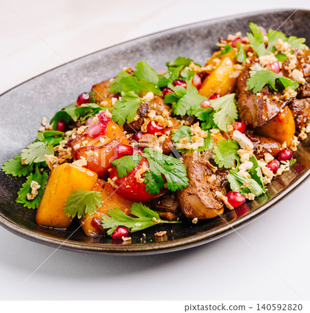 Gourmet chicken liver salad with pomegranate and cilantro 140592820