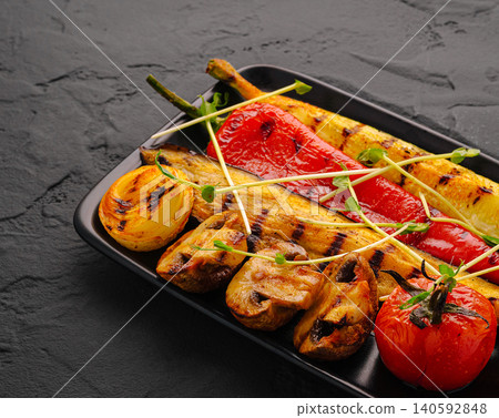 Grilled mixed vegetables on black plate with sprouts 140592848