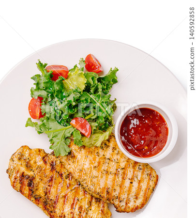 Grilled chicken breast with fresh green salad and sauce Grilled chicken breast with fresh green salad and sauce 140592858