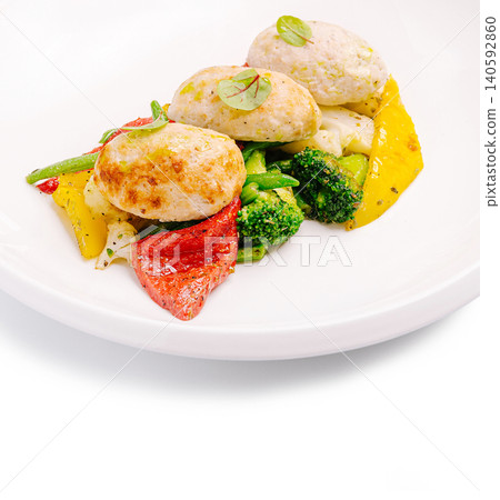 Plating chicken cutlets with steamed vegetables on white plate Plating chicken cutlets with steamed vegetables on white plate 140592860
