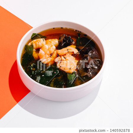 Miso soup with salmon, shrimp, wakame, and mushrooms Miso soup with salmon, shrimp, wakame, and mushrooms 140592878