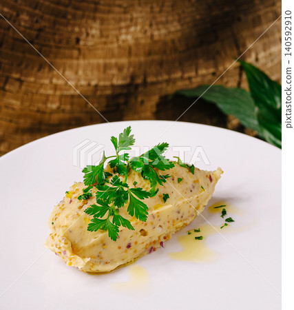 Creamy hummus dip garnished with fresh parsley and olive oil Creamy hummus dip garnished with fresh parsley and olive oil 140592910