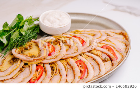 Sliced meat roll appetizer with sauce and fresh herbs Sliced meat roll appetizer with sauce and fresh herbs 140592926