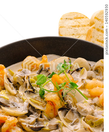 Seafood dish with clams shrimp mushrooms creamy sauce Seafood dish with clams shrimp mushrooms creamy sauce 140592930