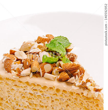 Slice of almond cream cake with mint garnish 140592952