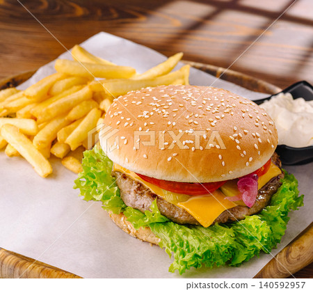 Cheeseburger and french fries with sauce combo meal 140592957