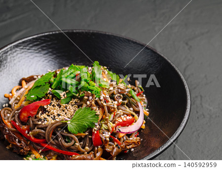 Soba noodle stir-fry with vegetables and sesame seeds 140592959