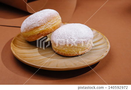 Powdered sugar donuts presenting sweet pastry dessert Powdered sugar donuts presenting sweet pastry dessert 140592972
