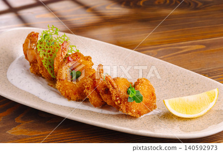 Fried shrimp tempura serving with sauce and lemon Fried shrimp tempura serving with sauce and lemon 140592973