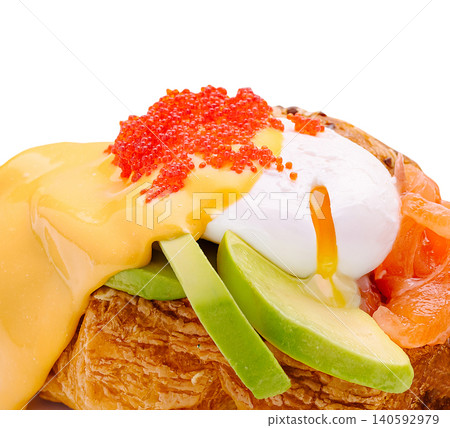 Croissant benedict with poached egg salmon avocado roe 140592979