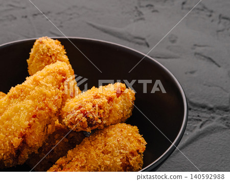 Crispy golden fried chicken wings in bowl Crispy golden fried chicken wings in bowl 140592988