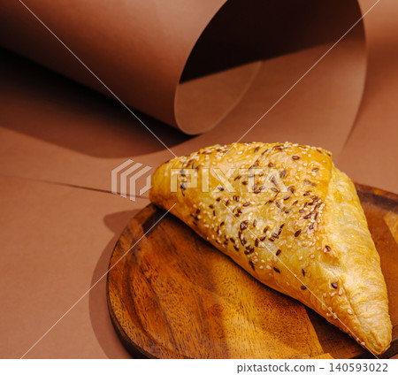 Puff pastry samsa turnover on wooden plate Puff pastry samsa turnover on wooden plate 140593022