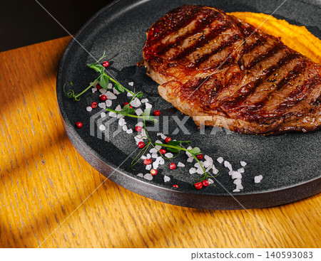 Grilled ribeye beef steak with sweet puree Grilled ribeye beef steak with sweet puree 140593083